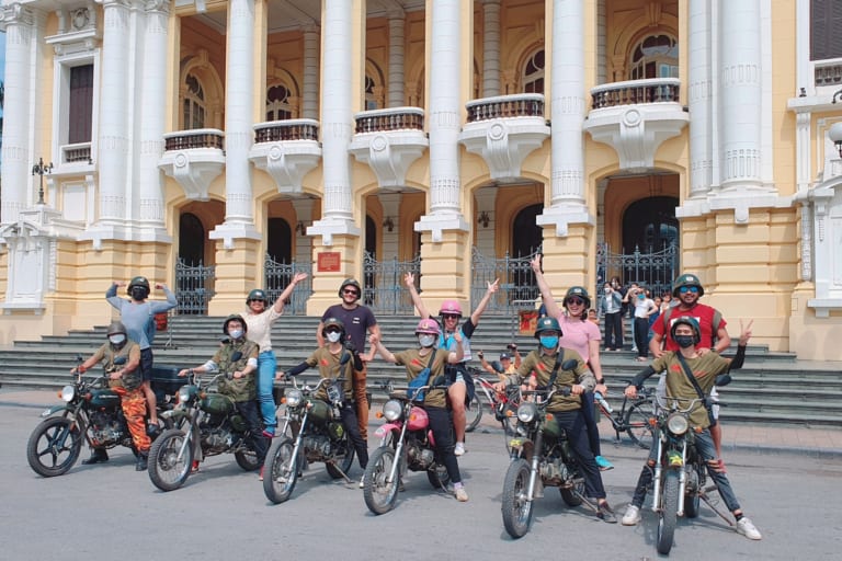 Tourists on vintage Minsk motorbikes in front of Hanoi Opera House – Hanoi motorbike tours